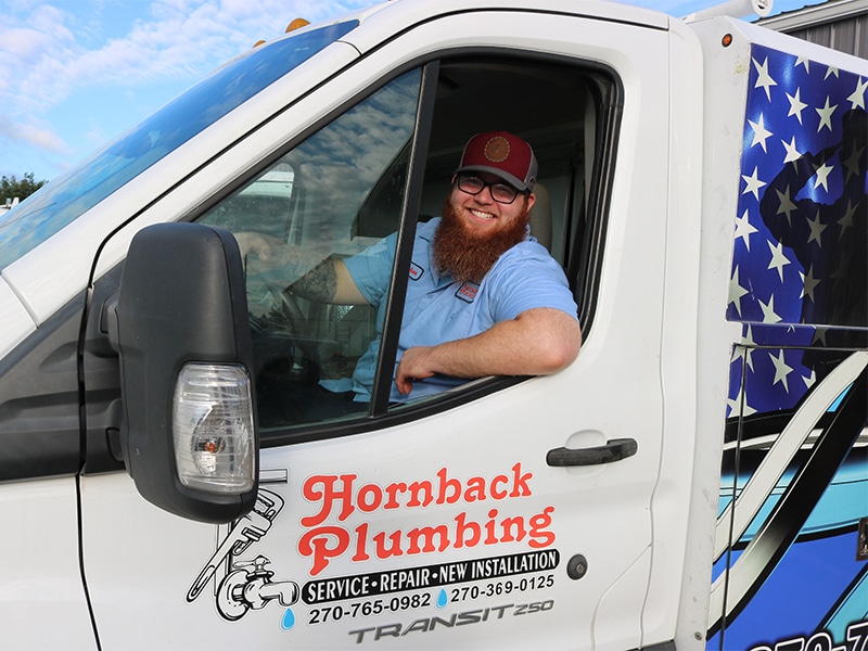 a man standing in front of a car